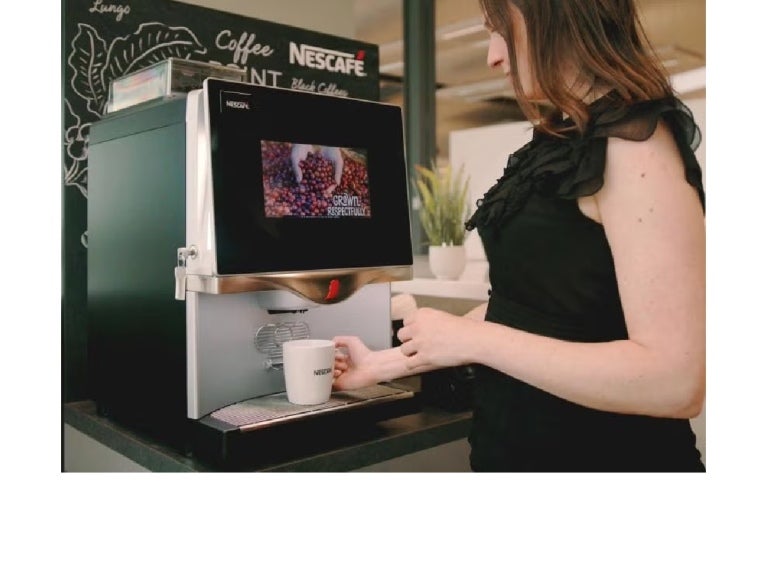 Person using a Nescafé coffee machine