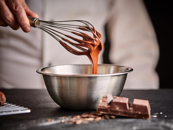 A Chef using Nestlé Chocolates brand products in a bowl.