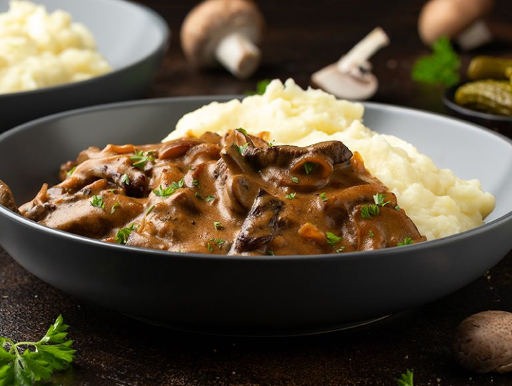 Maggie mash plate served with stew meat dish